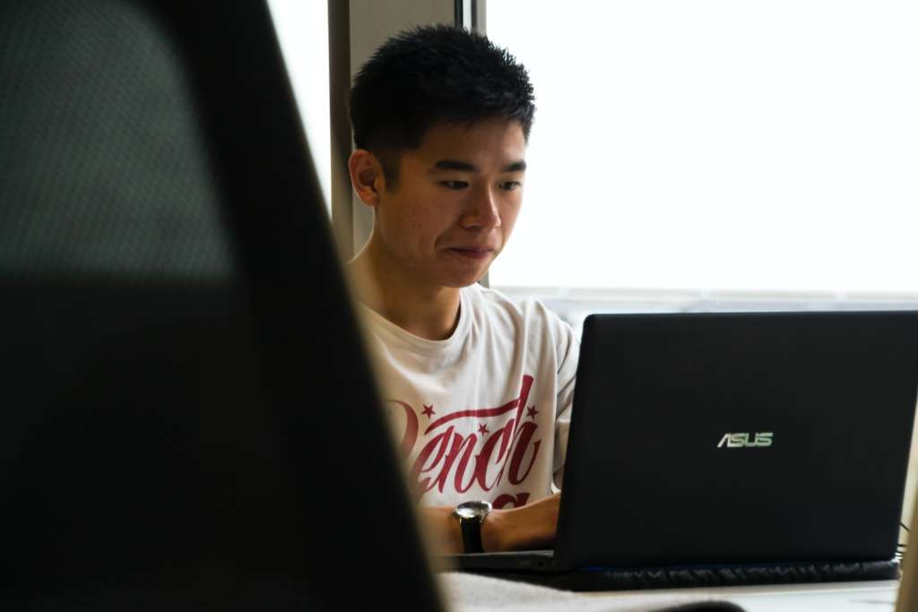 man sitting while using chatgpt on laptop